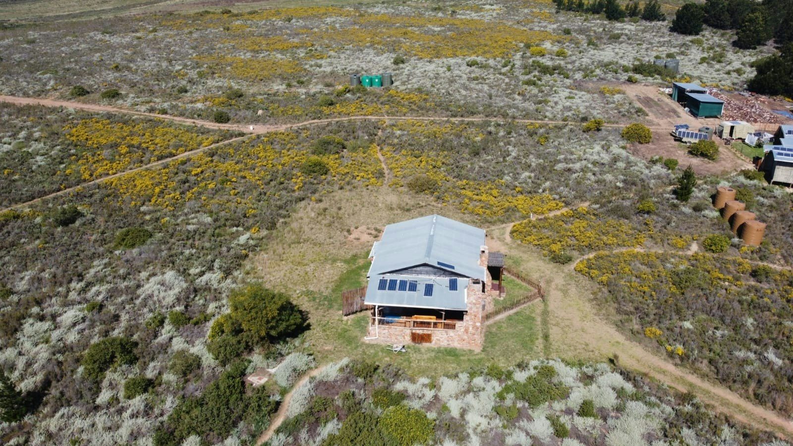 Drone view of the house among the fynbos with gravel tracks around it