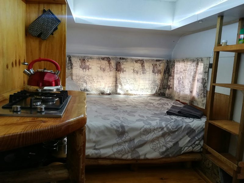 Inside the BushCat caravan: the bed and the gas stove
