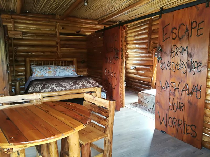 A barn door inside Meerkat burned with the words Escape from everyday life, wash away your worries